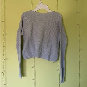 blue Hollister sweater crossed in back